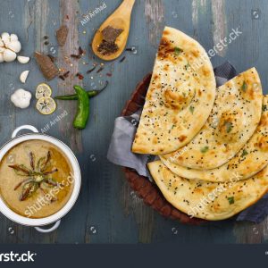 A table with some food and a bowl of soup