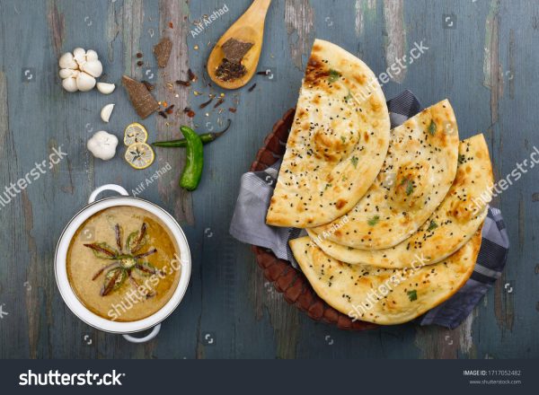 A table with some food and a bowl of soup