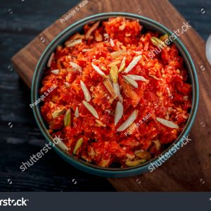 A bowl of food on top of a wooden board.