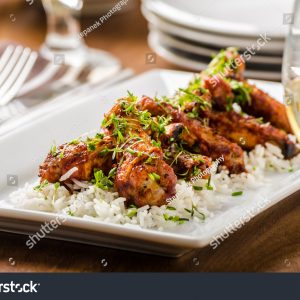 A plate of food on top of white rice.