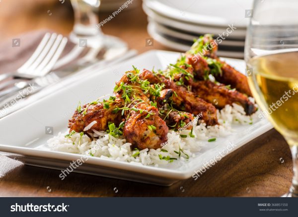 A plate of food on top of white rice.