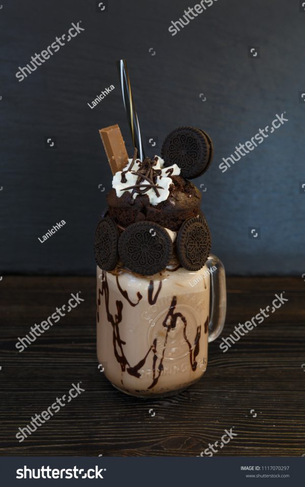 A cup of chocolate ice cream with cookies and marshmallows.