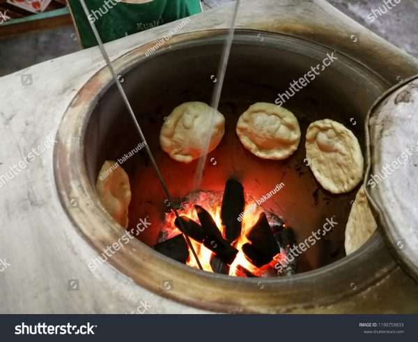 A pot of food cooking on the fire.