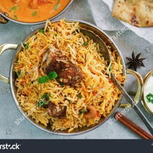 A bowl of rice and meat on the table