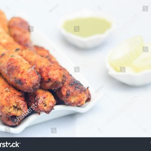 A plate of food with some sauce and other foods