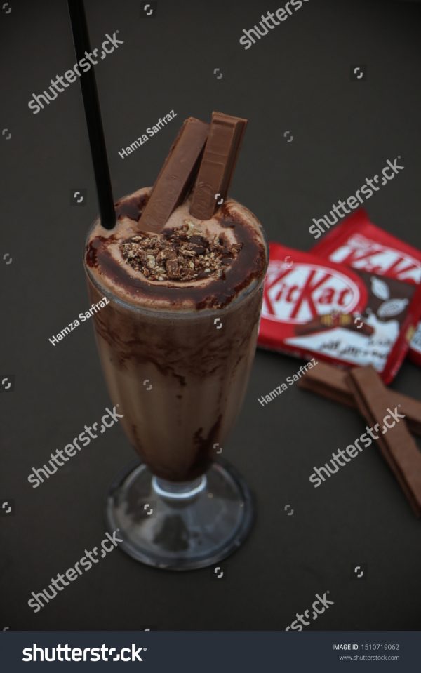 A chocolate milkshake with a straw in it