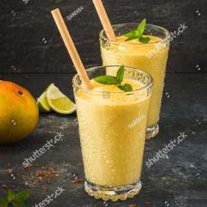 Two glasses of orange juice with a straw in them