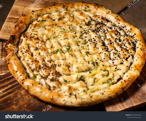 A pizza sitting on top of a wooden cutting board.