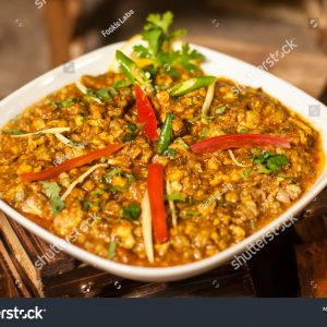 A bowl of food with some meat and vegetables