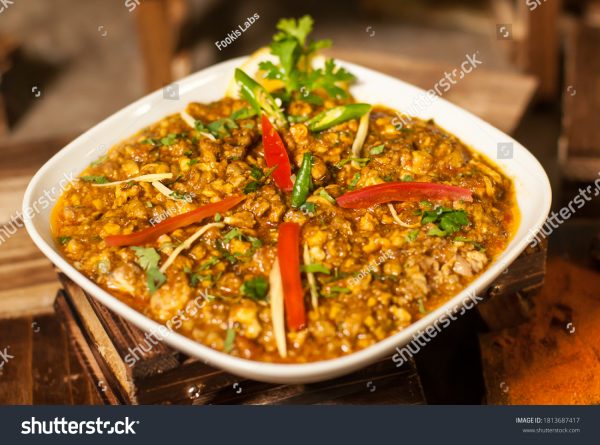 A bowl of food with some meat and vegetables