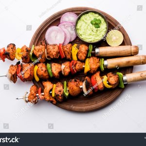 A wooden plate with some food on it