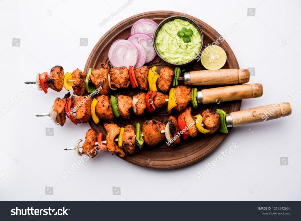 A wooden plate with some food on it