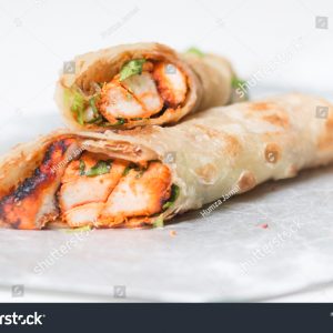 A close up of two burritos on a plate