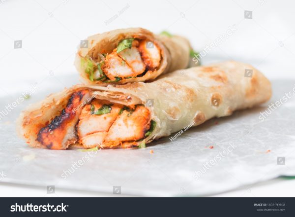 A close up of two burritos on a plate