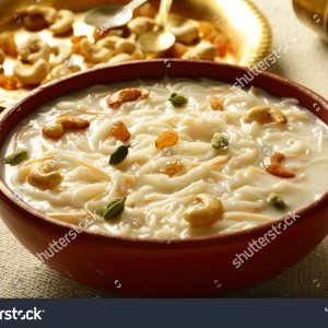 A bowl of food on the table with some other foods