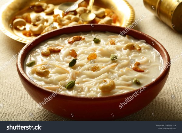 A bowl of food on the table with some other foods