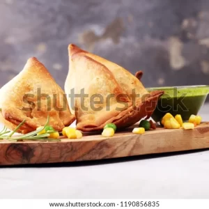 A wooden tray with two pieces of food on it