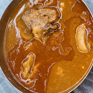 A pan of food that is covered in gravy.