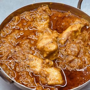 A pan of food with meat and sauce.